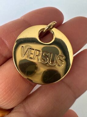 Bundle of two golden Versace medallions